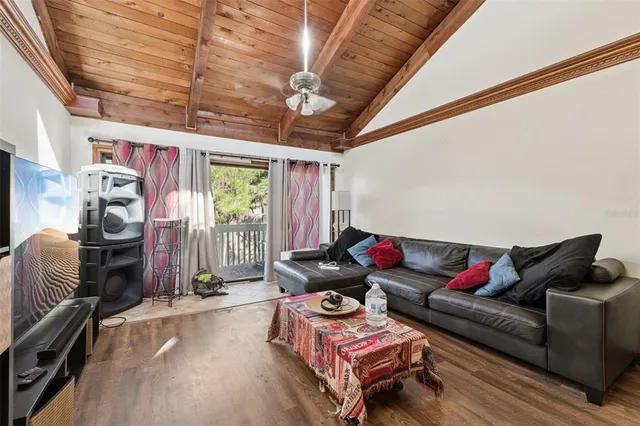 a living room with furniture a air conditioner vent and a window