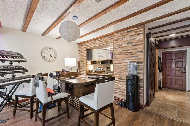 a view of a room that has a table and chairs in it