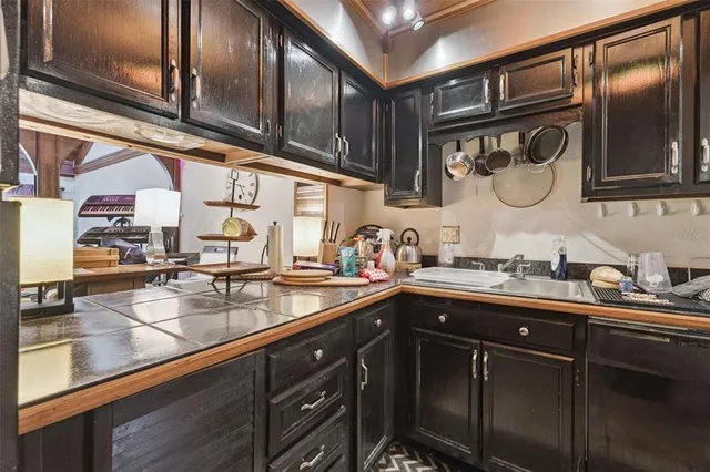 a kitchen with stainless steel appliances granite countertop a sink stove and cabinets
