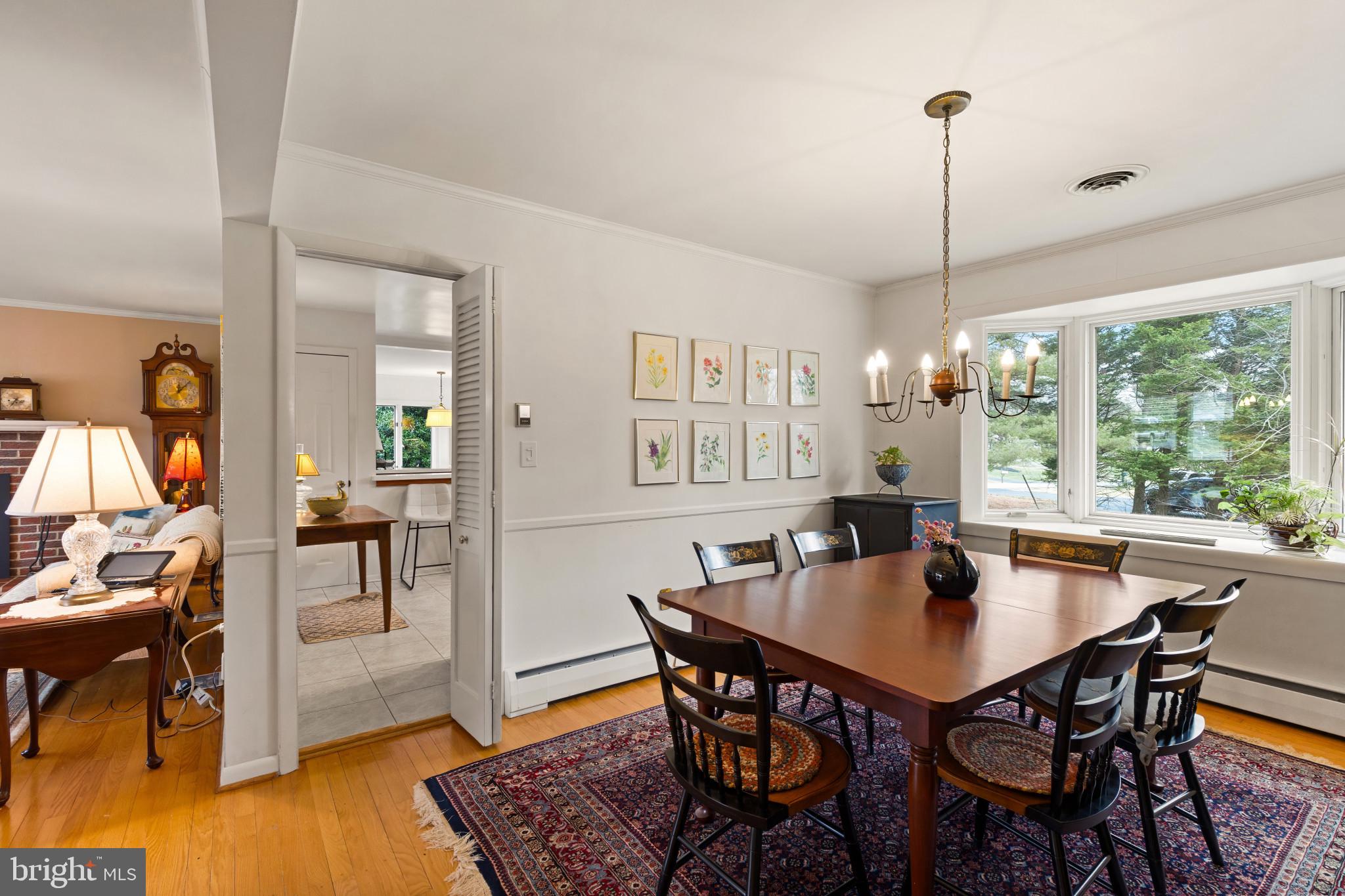 8419 High Ridge Road Ellicott City, MD 21043 - Photo 11 of 49 a view of a dining room with furniture window and wooden floor