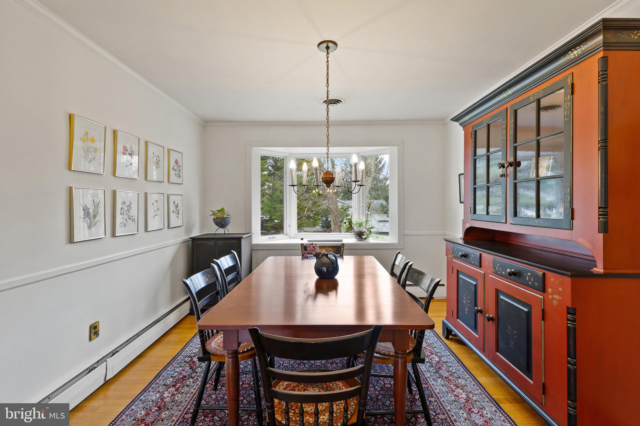 8419 High Ridge Road Ellicott City, MD 21043 - Photo 12 of 49 a dining room with furniture a rug and wooden floor