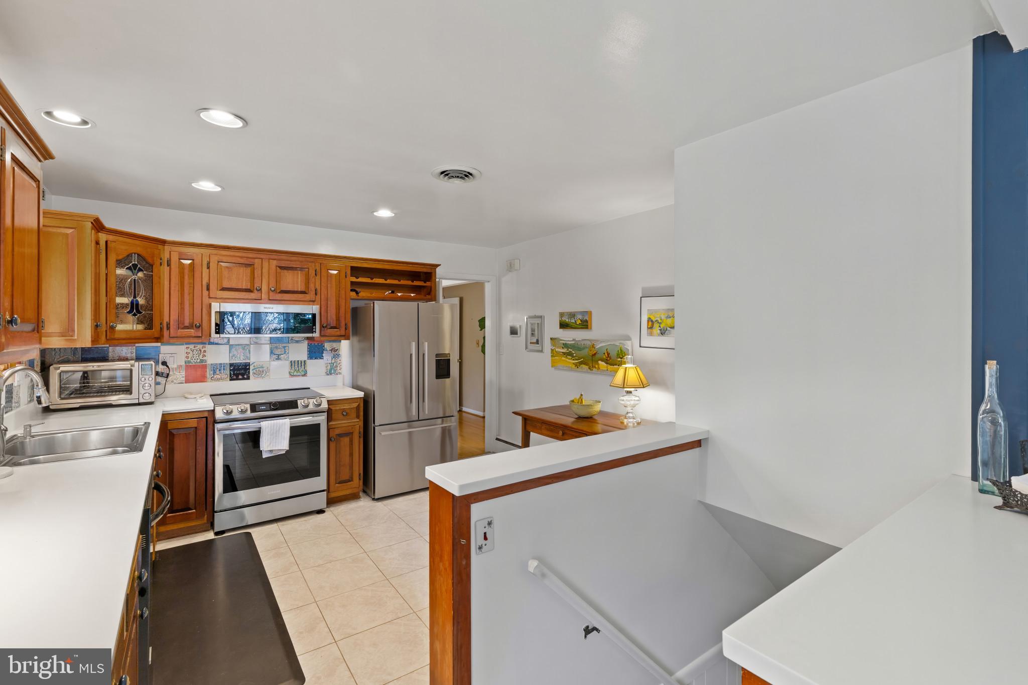 8419 High Ridge Road Ellicott City, MD 21043 - Photo 18 of 49 a kitchen with stainless steel appliances granite countertop a sink stove and refrigerator
