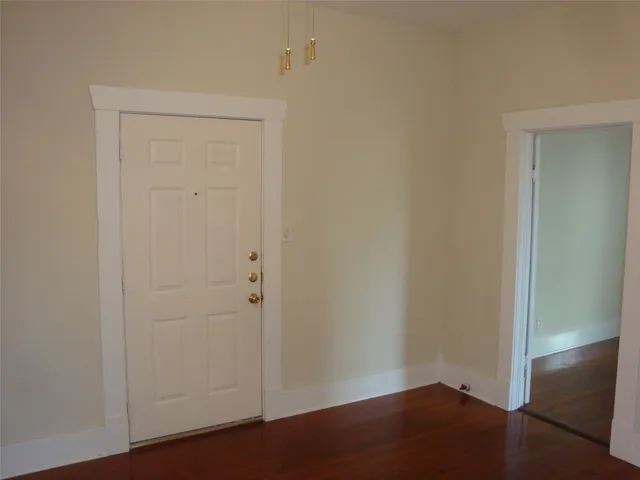 an empty room with wooden floor