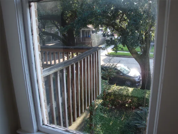 a view of a house with a tree in front
