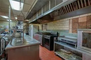 a kitchen with stove and cabinets