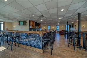 a room with furniture pool table and chairs