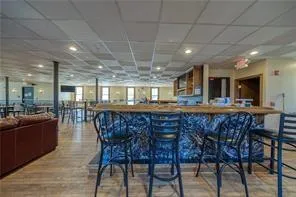 a dining hall with stainless steel appliances a dining table and chairs