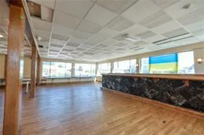 a view of room with wooden floor and windows