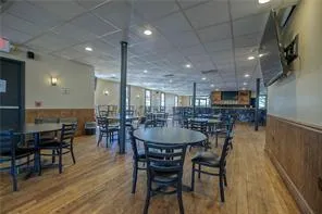 a dining room with furniture and wooden floor