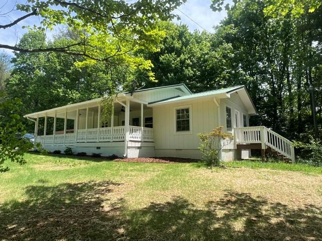 1616 Abe Cove Road Hiawassee, GA 30546 - Photo 5 of 17 a house that has a big yard in front of it