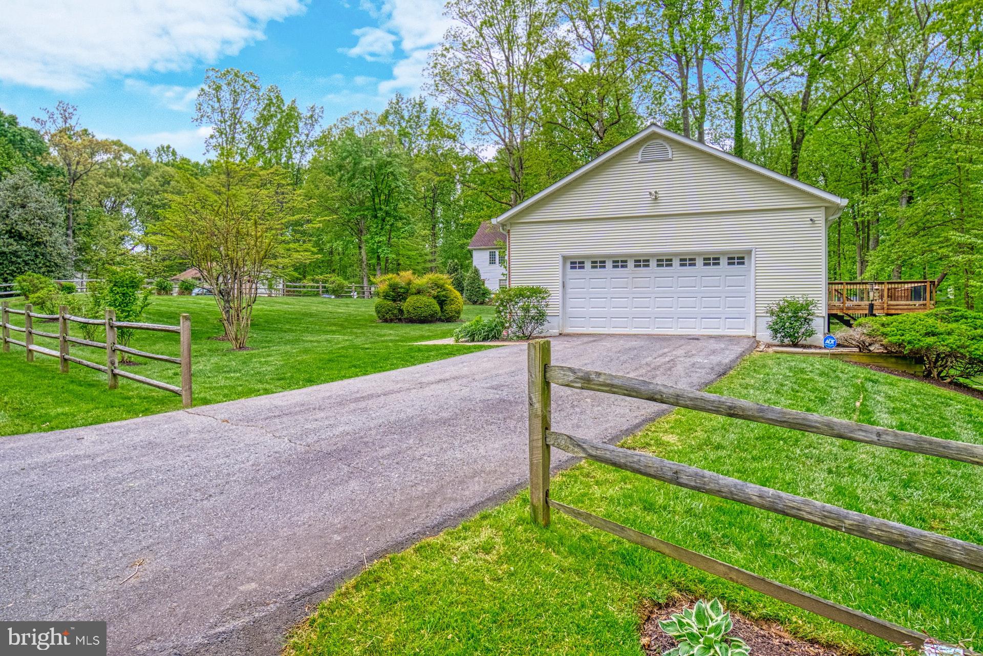 4913 Pheasant Ridge Road Fairfax, VA 22030 - Photo 3 of 33 Side-load garage and split-rail fence on 3 sides
