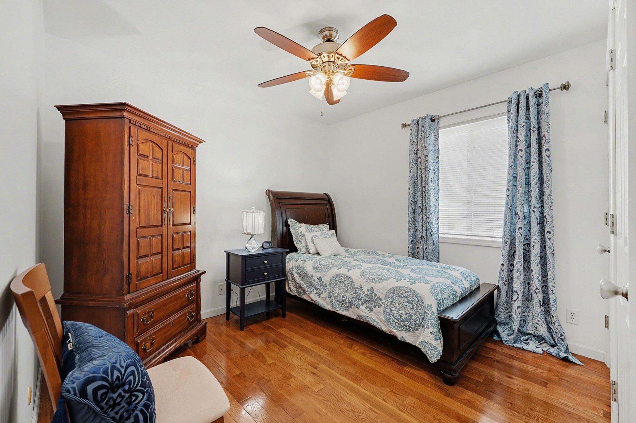 121 North West Street, Unit 22 Crown Point, IN 46307 - Photo 12 of 18 a bedroom with a bed and a chandelier