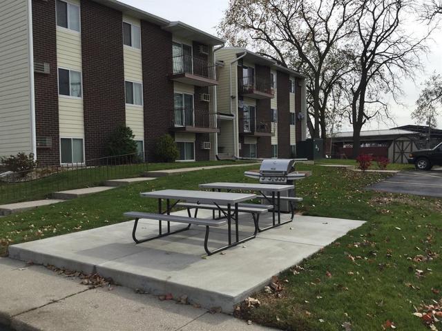 121 North West Street, Unit 22 Crown Point, IN 46307 - Photo 14 of 18 a park bench sitting in the middle of a park