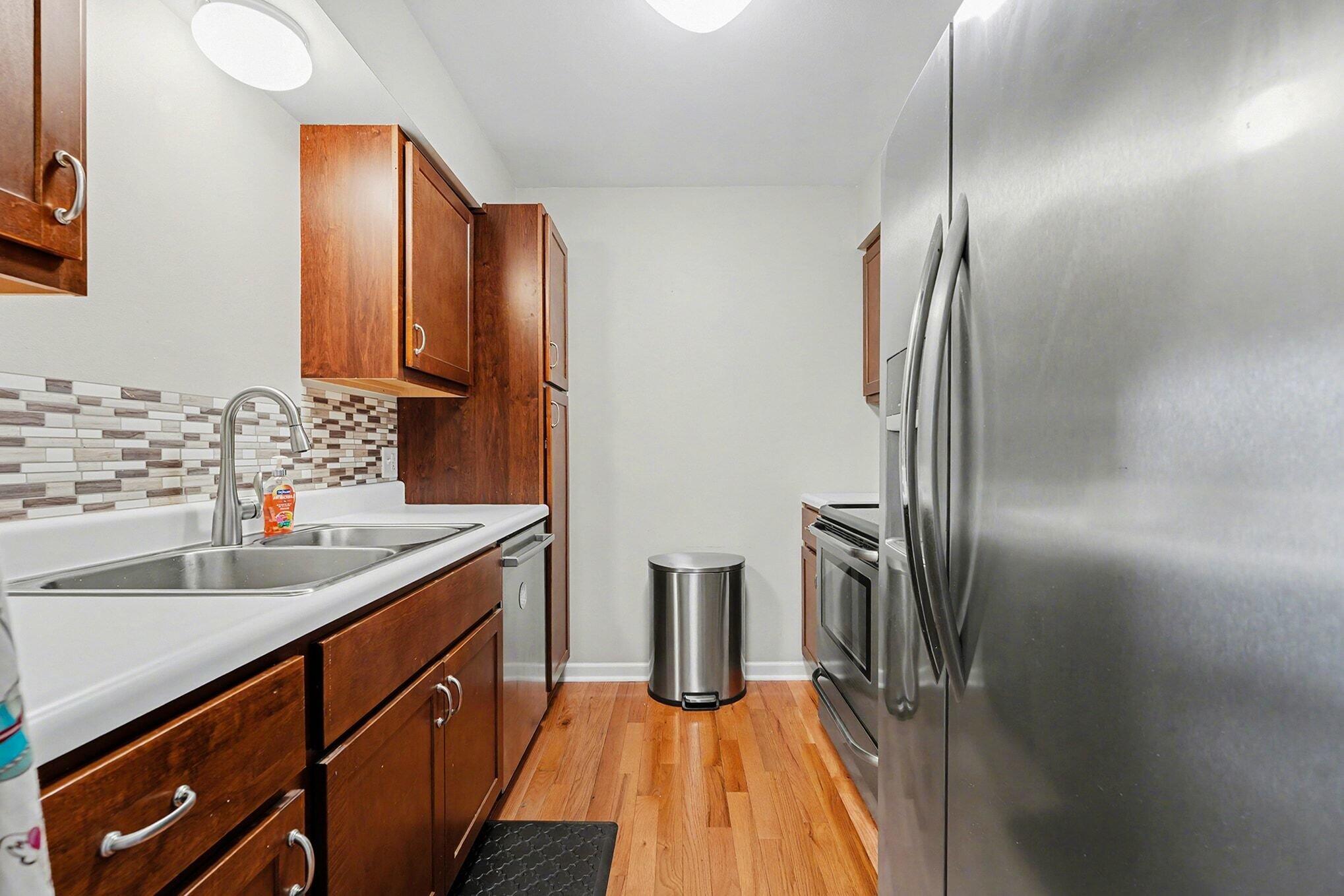 121 North West Street, Unit 22 Crown Point, IN 46307 - Photo 4 of 18 a kitchen with stainless steel appliances granite countertop a refrigerator and a sink