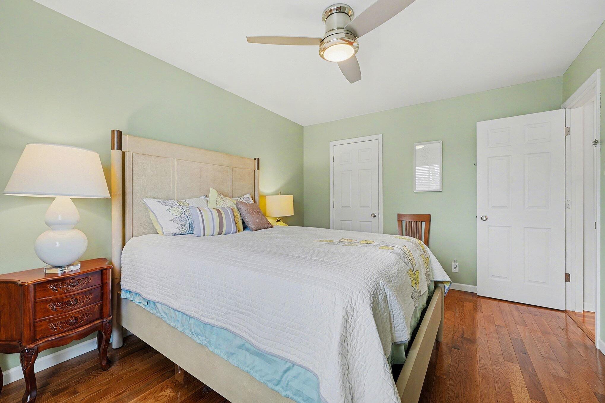 121 North West Street, Unit 22 Crown Point, IN 46307 - Photo 9 of 18 a bedroom with a bed and wooden floor