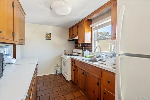 a kitchen with a sink cabinets and a window