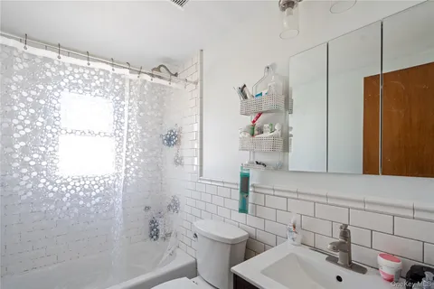 a bathroom with a shower and a sink