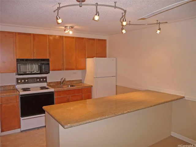 a kitchen with a stove a refrigerator and a sink