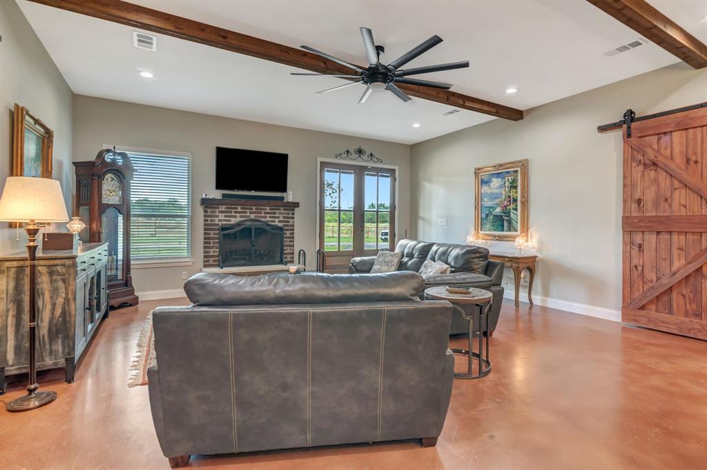 129 Whiskey Rnch Road Runaway Bay, TX 76426 - Photo 9 of 39 a living room with fireplace furniture and a flat screen tv