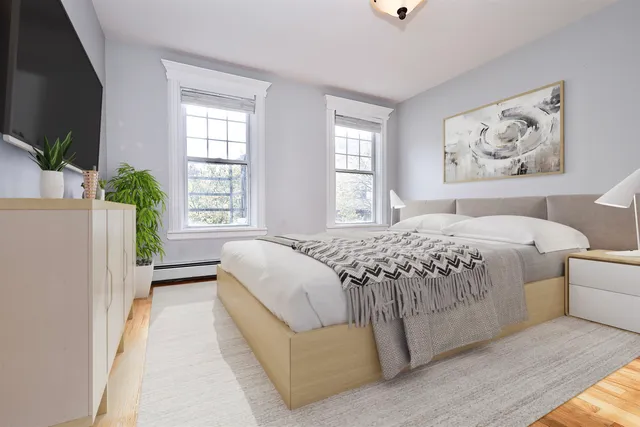 a bedroom with a large bed and a window