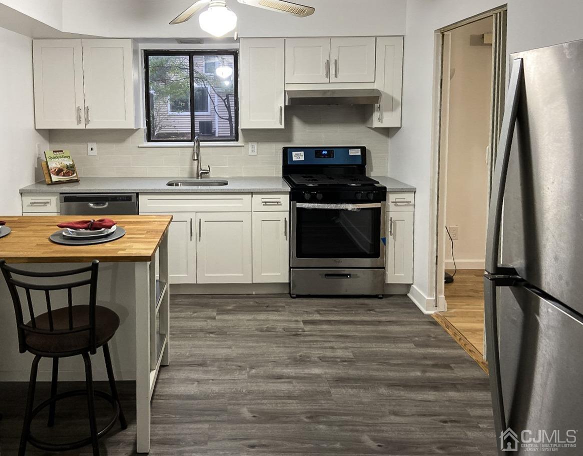 5403 Hana Road Edison, NJ 08817 - Photo 1 of 12 a kitchen with stainless steel appliances a stove a sink refrigerator and cabinets