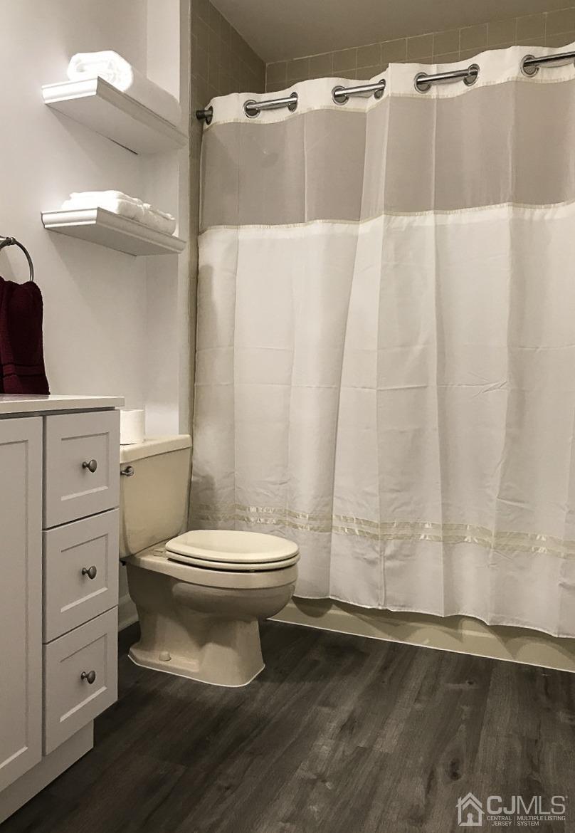 5403 Hana Road Edison, NJ 08817 - Photo 3 of 12 a bathroom with a toilet a sink and a shower