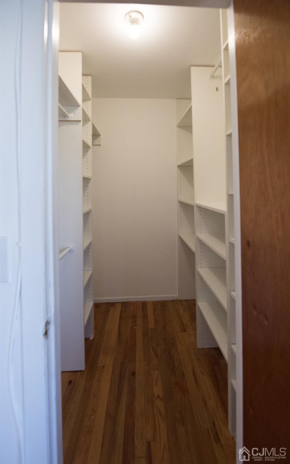 5403 Hana Road Edison, NJ 08817 - Photo 6 of 12 a view of walk in closet with empty racks