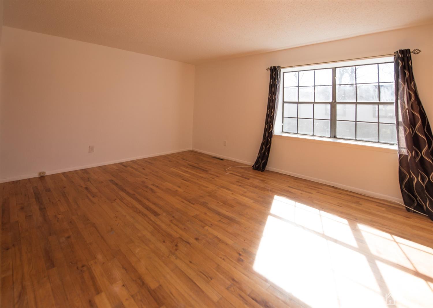 5403 Hana Road Edison, NJ 08817 - Photo 9 of 12 a view of empty room with wooden floor and fan