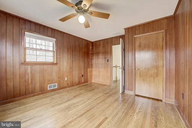 a bathroom with a granite countertop sink a mirror and a bathtub