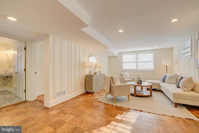 a view of a hallway with wooden floor and entryway
