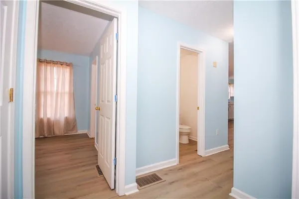 a view of a hallway with wooden floor