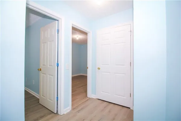 a view of a room with wooden floor and bench