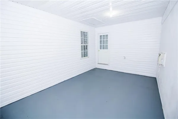 a view of a yard with wooden fence