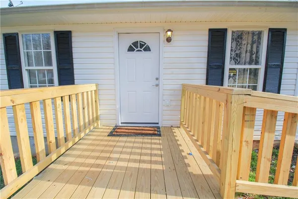 a view of a house with a door and wooden floor