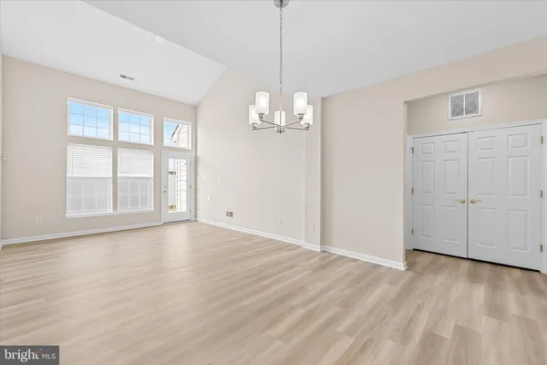 a view of a livingroom with wooden floor and a window