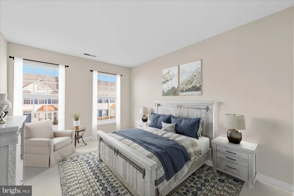 a bedroom with bed couch and window