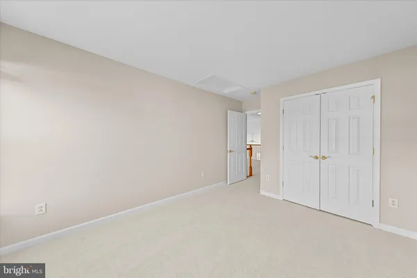 a view of an empty room and closet area