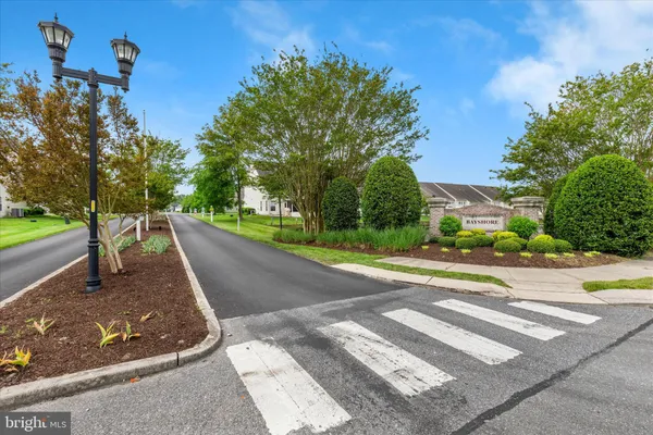 a view of a street with a building and a street sign