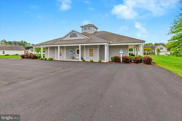 a view of a house with a garden and pathway