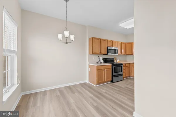 a kitchen with stove refrigerator and microwave