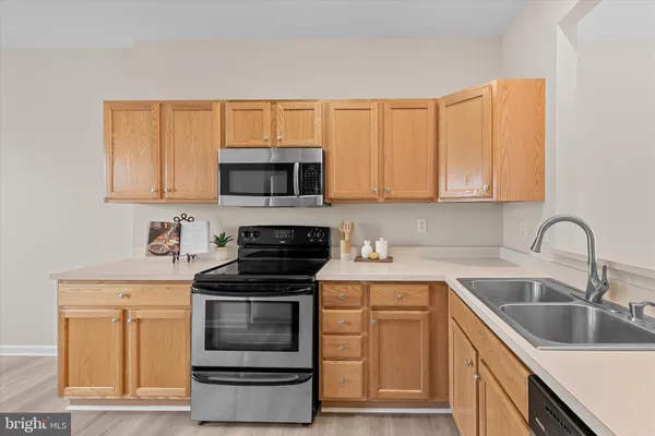 a kitchen with granite countertop a sink and a stove top oven