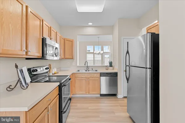 a kitchen with a refrigerator sink stove and cabinets
