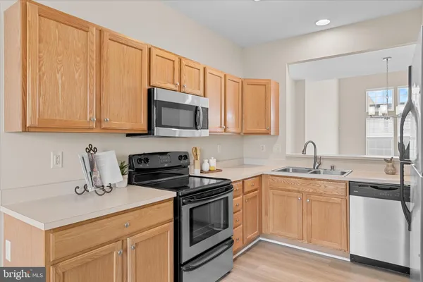 a kitchen with a sink stove and microwave
