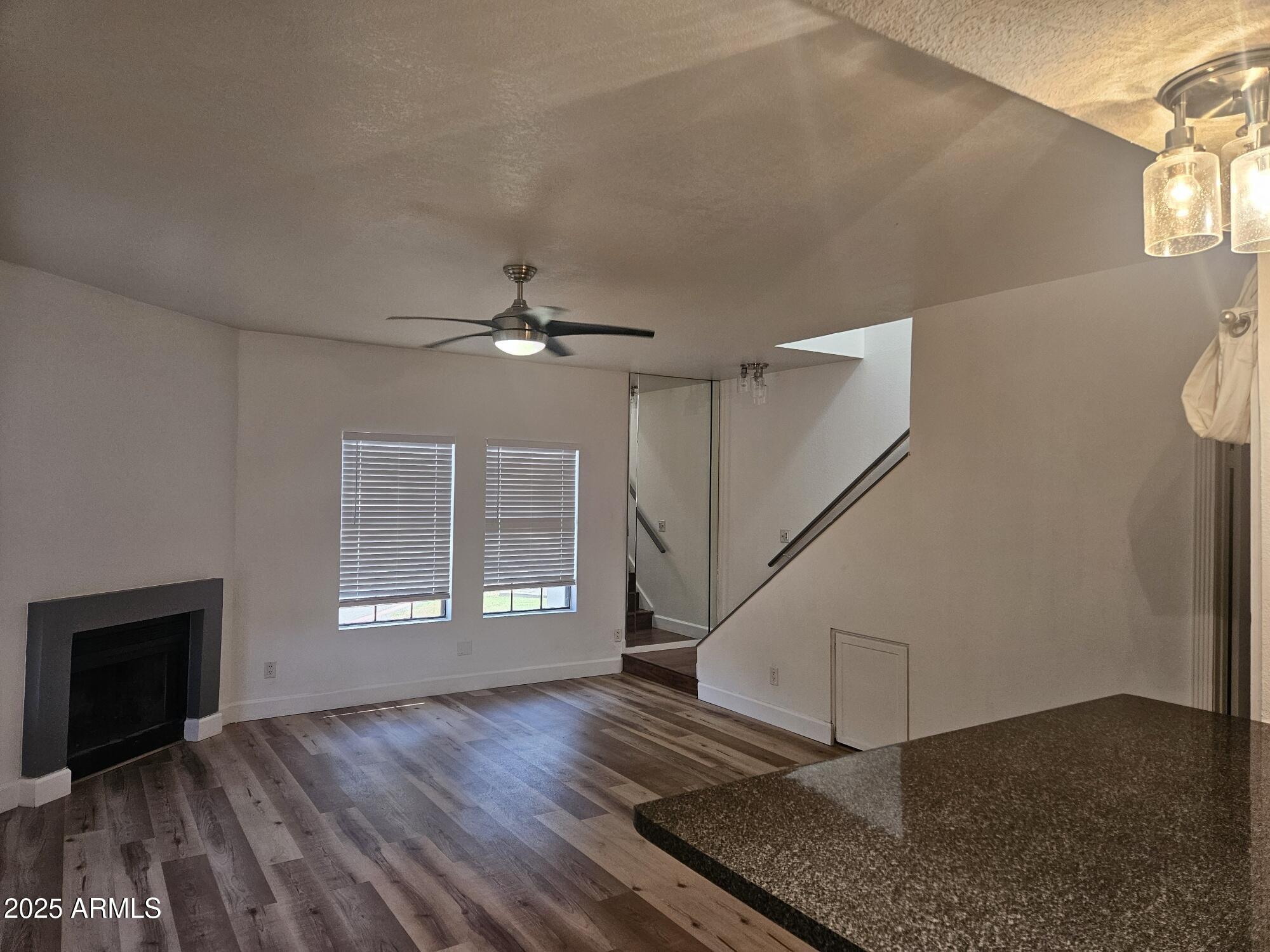 1245 West 1st Street, Unit 127 Tempe, AZ 85281 - Photo 3 of 15 a view of an empty room with a window and wooden floor