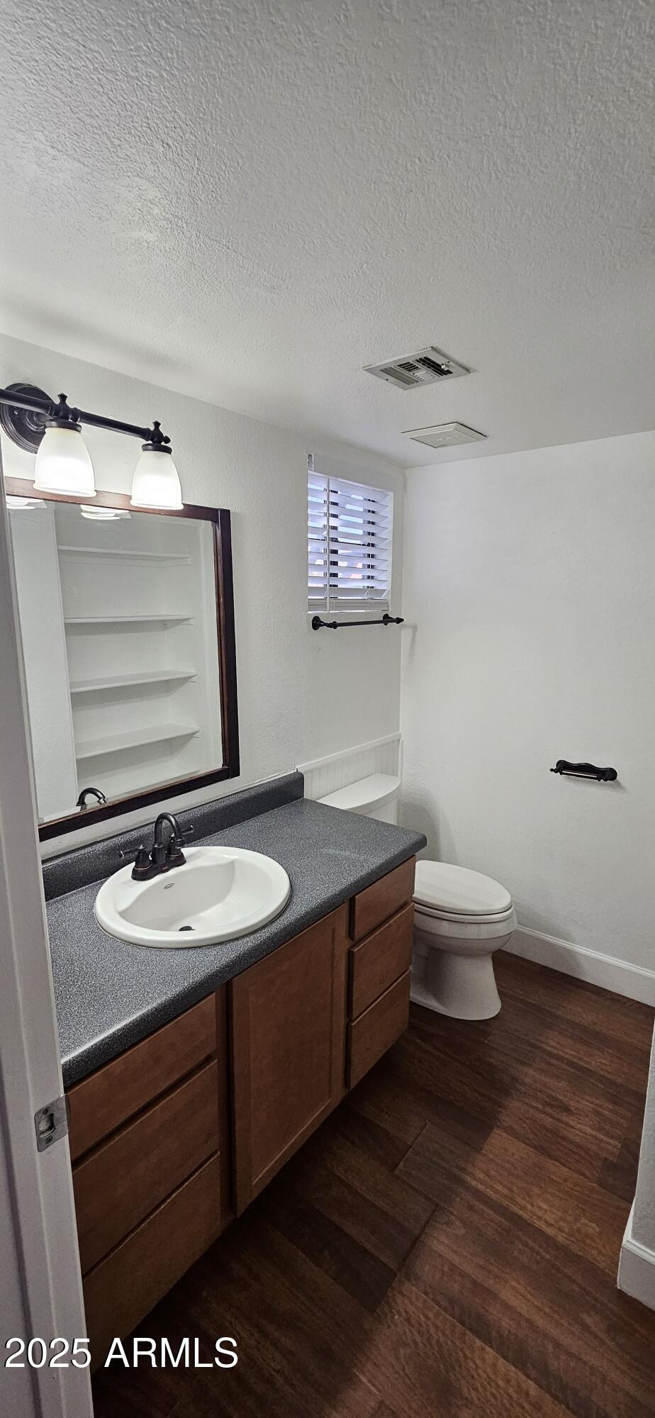 1245 West 1st Street, Unit 127 Tempe, AZ 85281 - Photo 10 of 15 a bathroom with a sink a toilet and mirror