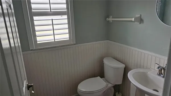 a white toilet sitting next to a bathroom sink