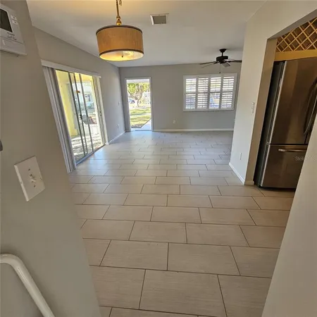 a view of an empty room with a fireplace and a window