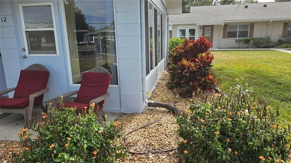 a view of a house with backyard sitting area and garden