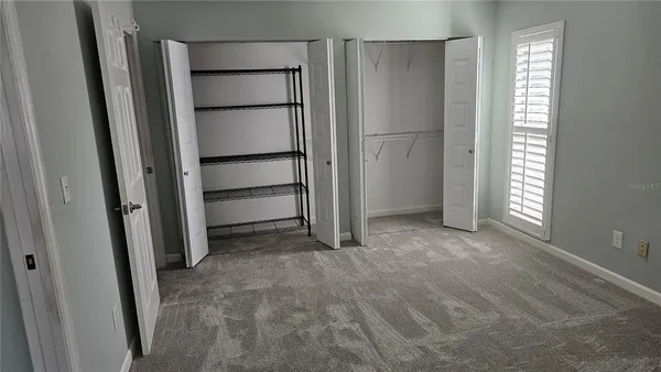 a view of an empty room with a closet
