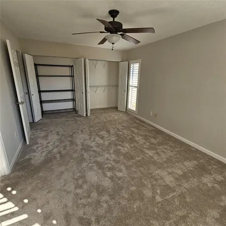 a view of room and chandelier fan